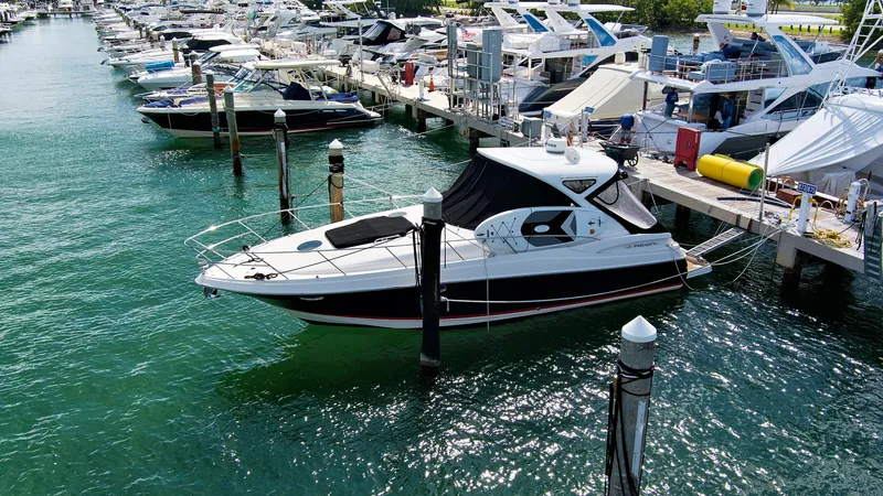 Slide: The Image of 2006 Regal 3560 COMMODORE yacht docked at a marina with other boats. - 6