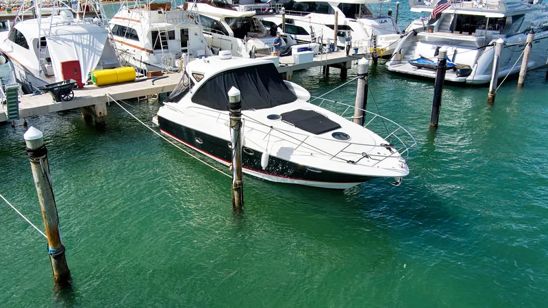 Slide: The Image of 2006 Regal 3560 COMMODORE yacht docked in a marina with clear green water. - 7
