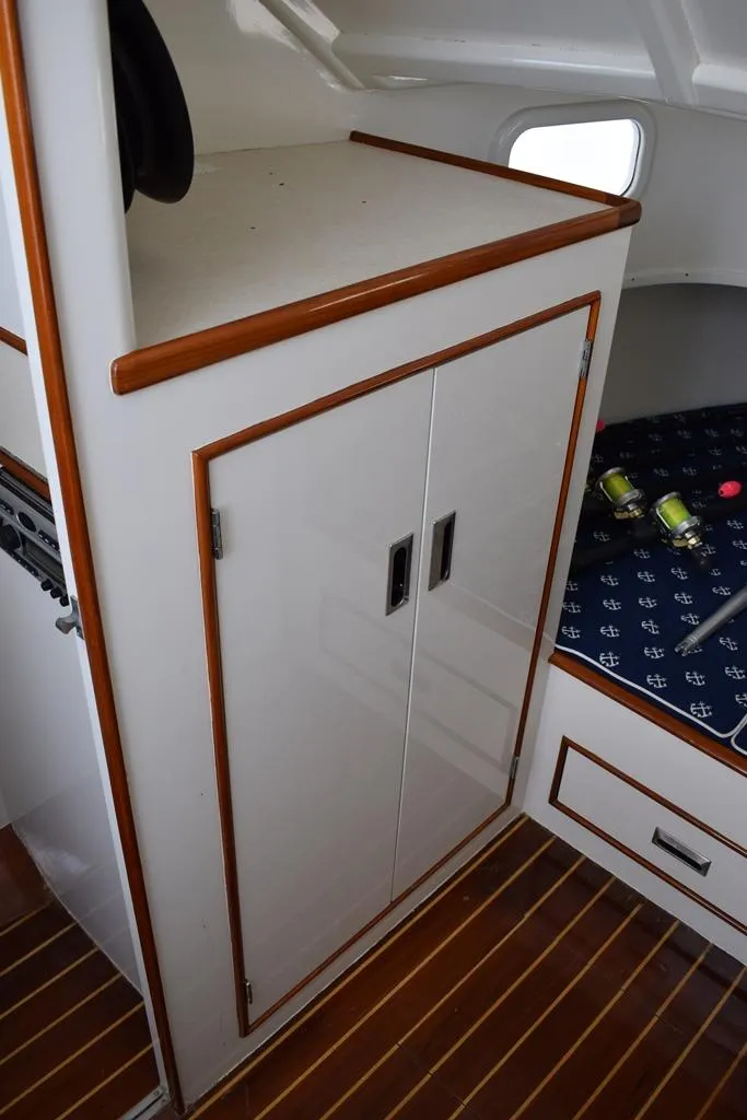 Slide: The Image of 1988 Rybovich Express Walkaround interior with wood accents and storage cabinets. - 10