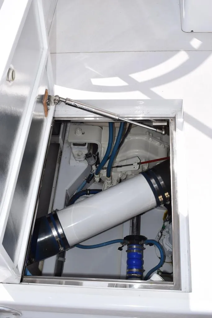 Slide: The Image of 1988 Rybovich Express Walkaround engine compartment with visible components and wiring. - 17