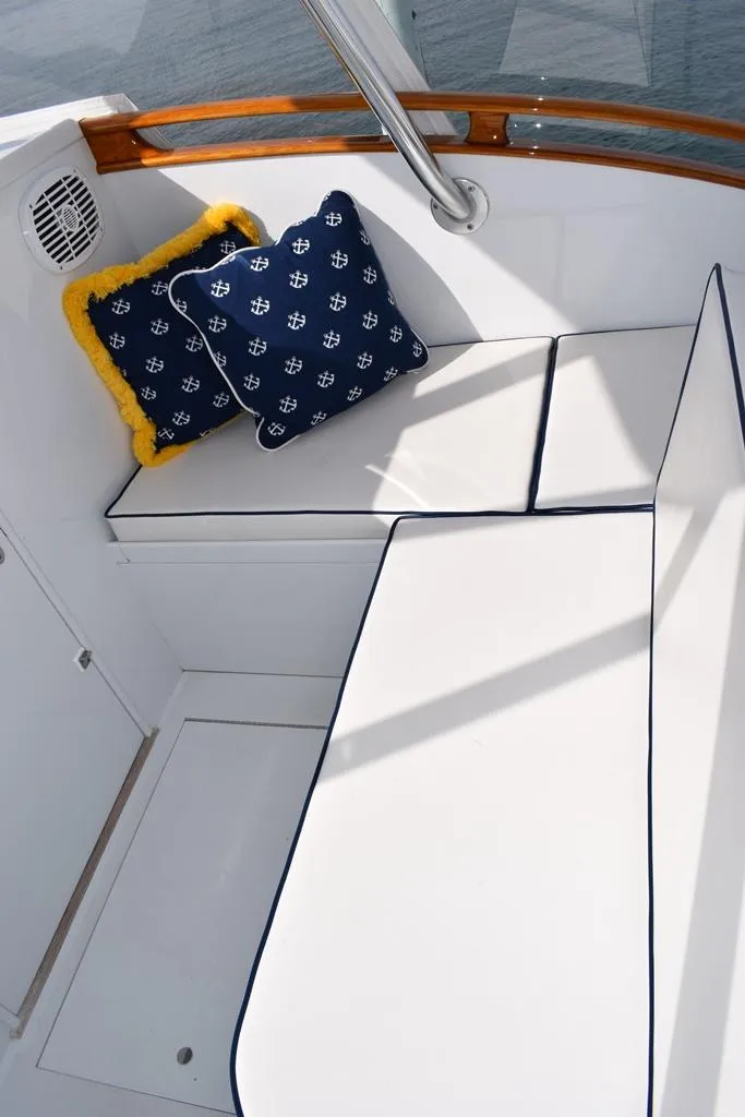 Slide: The Image of 1988 Rybovich Express Walkaround boat seating with nautical-themed cushions. - 5