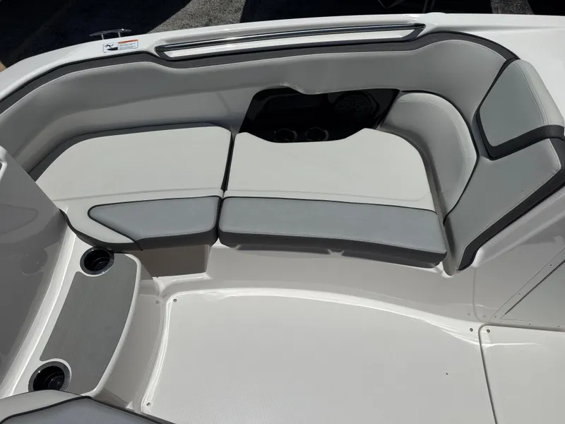 Slide: The Image of 2025 Yamaha AR250 boat interior with sleek gray seating and cup holders. - 11