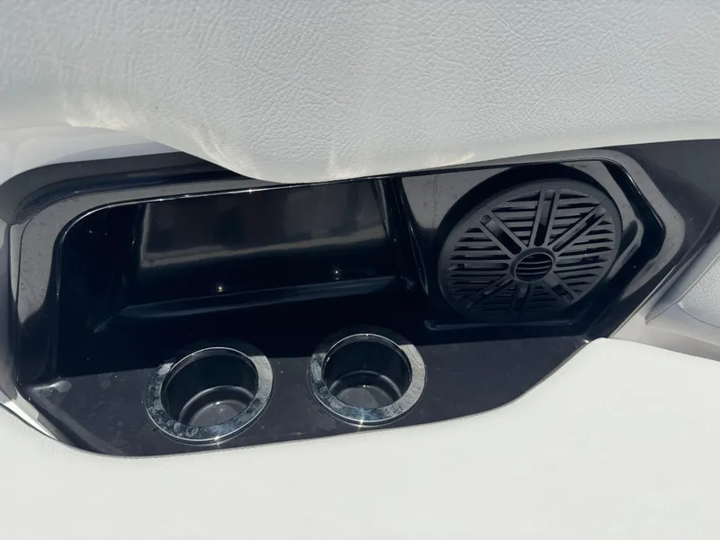Slide: The Image of 2025 Yamaha AR250 boat interior with cup holders and speaker. - 12