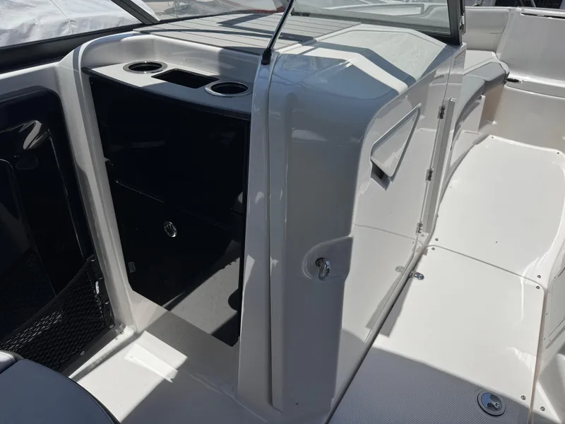 Slide: The Image of 2025 Yamaha Boats AR250 interior with sleek design and cup holders. - 14