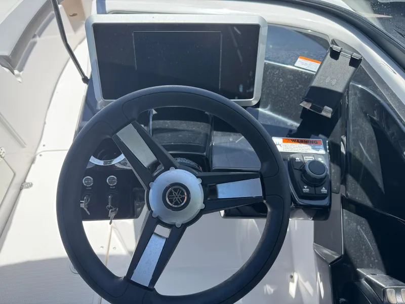 Slide: The Image of Steering wheel and dashboard of 2025 Yamaha Boats AR250. - 23