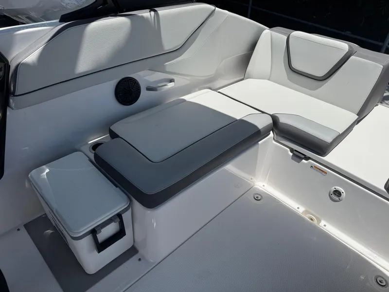 Slide: The Image of 2025 Yamaha Boats AR250 interior seating with storage and sleek design. - 27