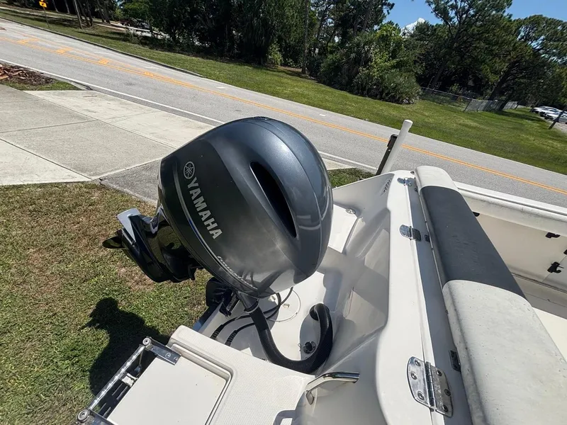 Slide: The Image of 2019 Robalo R222 Center Console with Yamaha outboard motor, parked on grass. - 8