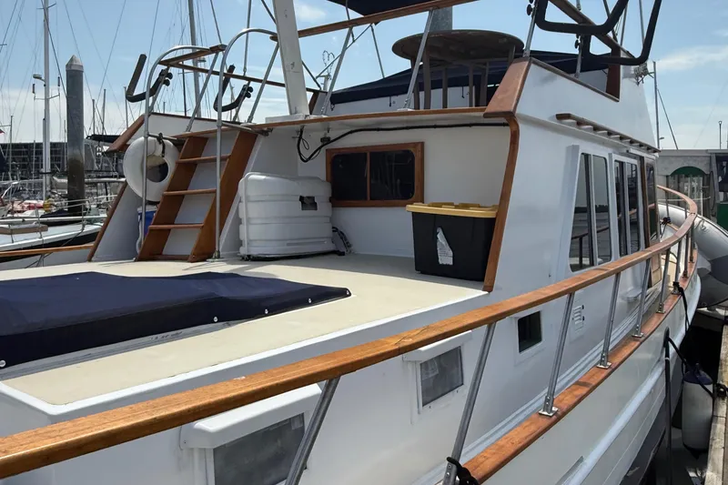 Slide: The Image of 1978 DeFever 39 yacht with wooden railings docked at a marina. - 12