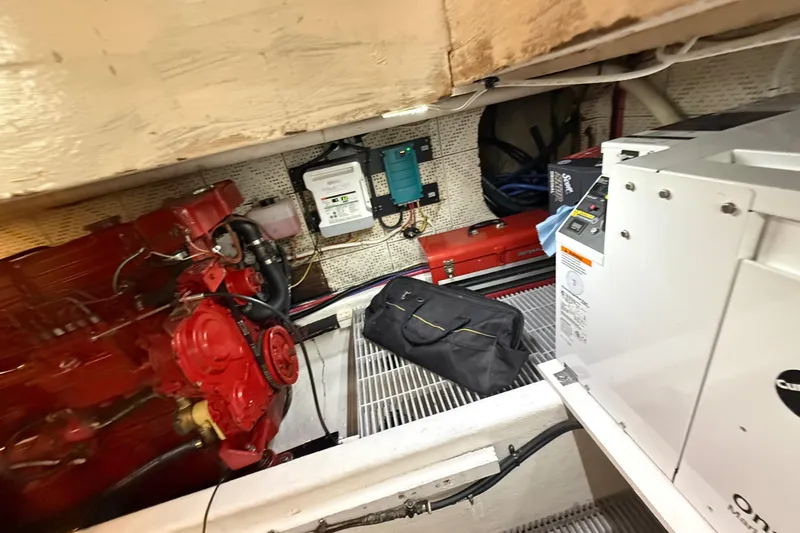 Slide: The Image of Engine room of a 1978 DeFever 39 boat with red engine and equipment. - 14