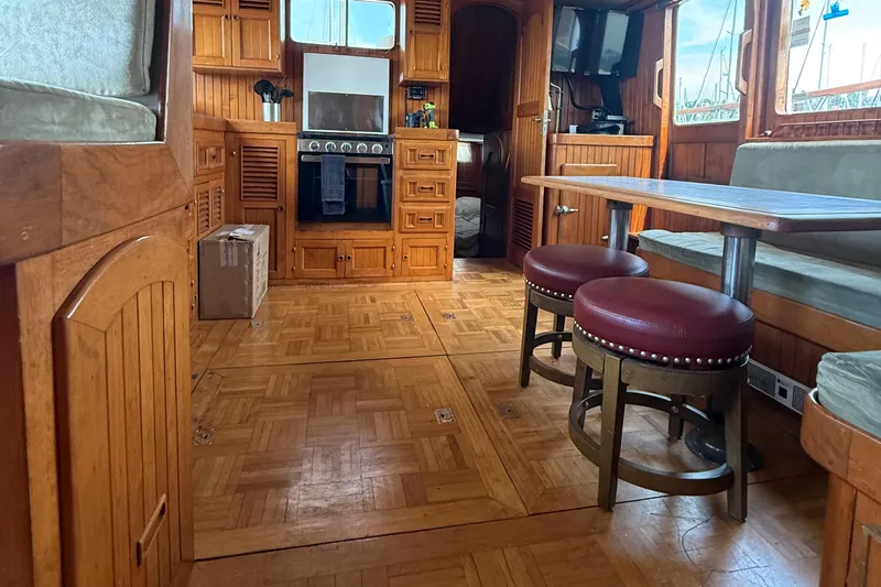Slide: The Image of Interior of 1978 DeFever 39 yacht with wooden cabinetry and dining area. - 9