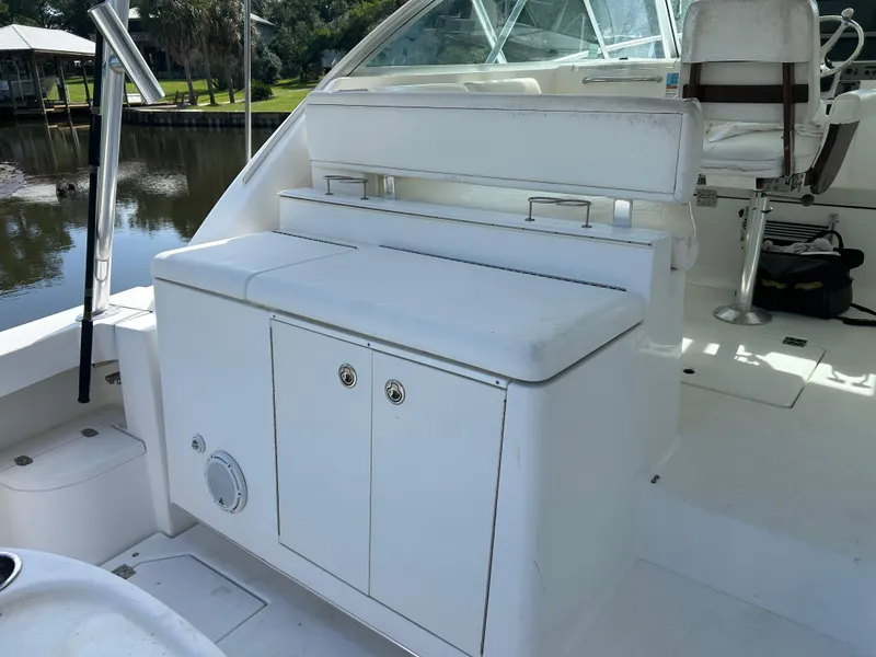 Slide: The Image of 2006 Rampage EXPRESS boat interior with white seating and storage compartments. - 11