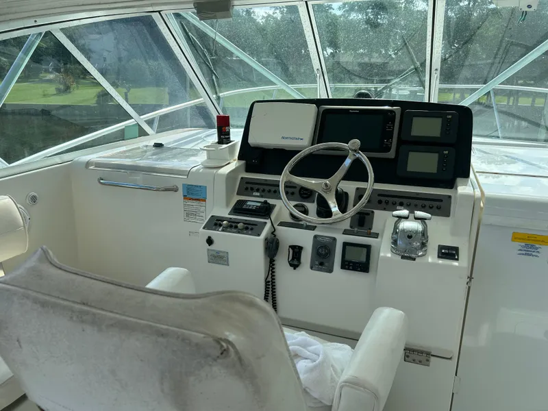 Slide: The Image of Helm of 2006 Rampage EXPRESS boat with steering wheel and navigation equipment. - 13
