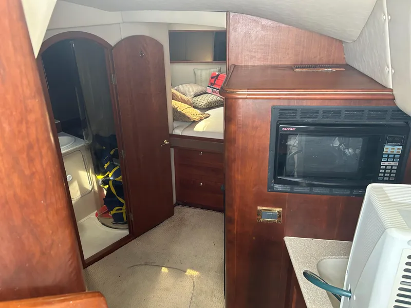 Slide: The Image of Interior of 2006 Rampage EXPRESS boat with microwave and cozy sleeping area. - 16