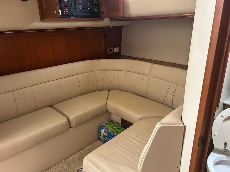 Slide: The Image of Interior of 2006 Rampage EXPRESS boat with beige seating and wooden cabinetry. - 18