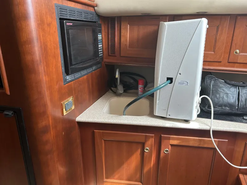 Slide: The Image of 2006 Rampage EXPRESS interior with microwave, sink, and wooden cabinetry. - 19