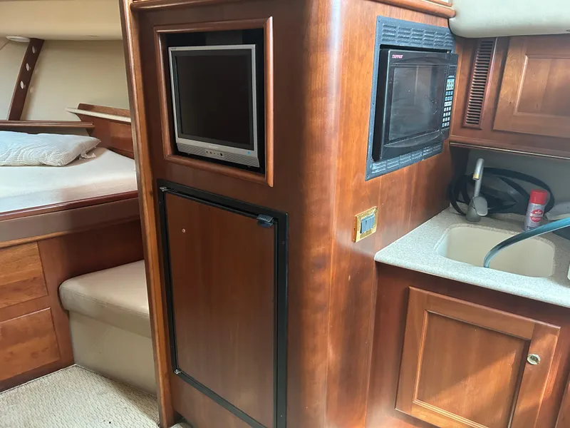 Slide: The Image of 2006 Rampage EXPRESS cabin interior with TV, microwave, sink, and bed. - 20