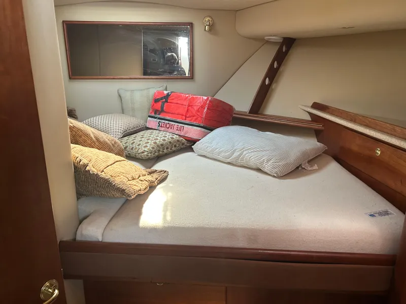 Slide: The Image of Cozy cabin interior of 2006 Rampage EXPRESS boat with pillows and life jacket. - 21