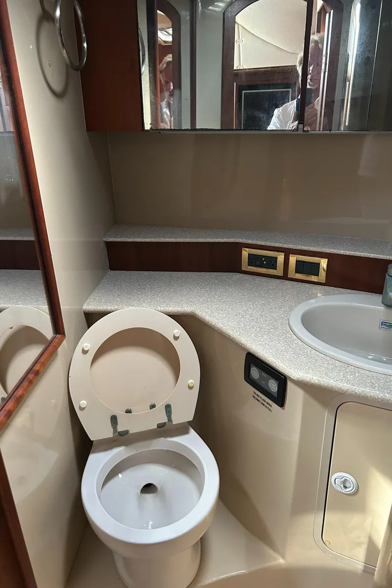 Slide: The Image of 2006 Rampage EXPRESS boat bathroom with toilet, sink, and mirror. - 27