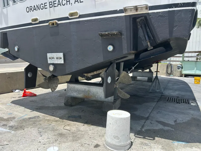 Slide: The Image of 2006 Rampage EXPRESS boat on dry dock, showing propellers and hull maintenance. - 32