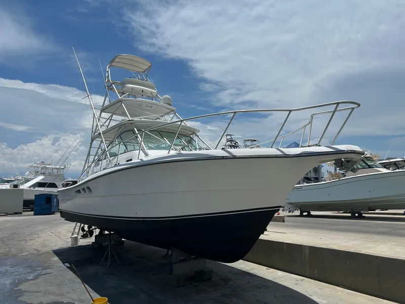 Slide: The Image of 2006 Rampage EXPRESS boat on dry dock under a clear sky. - 38