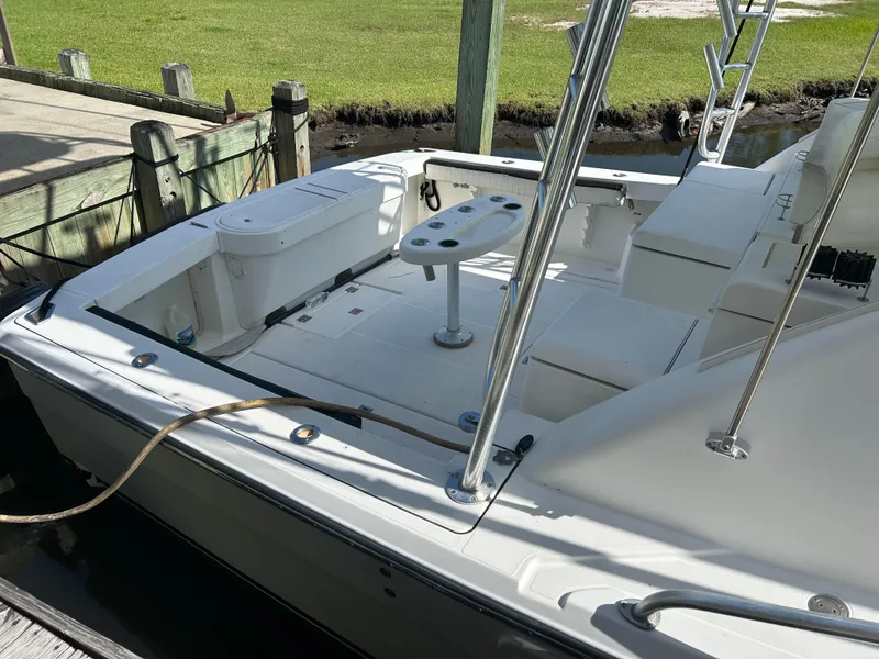 Slide: The Image of 2006 Rampage EXPRESS boat docked, featuring spacious deck and fishing equipment. - 6