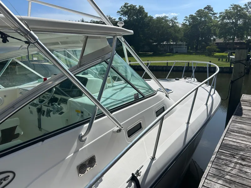 Slide: The Image of 2006 Rampage EXPRESS boat docked, showcasing sleek design and spacious cockpit. - 7