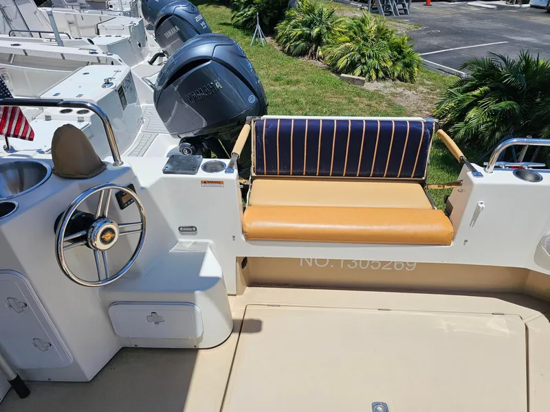 Slide: The Image of 2014 Ranger Tugs 31-CB boat interior with steering wheel, seating, and Yamaha engines. - 13