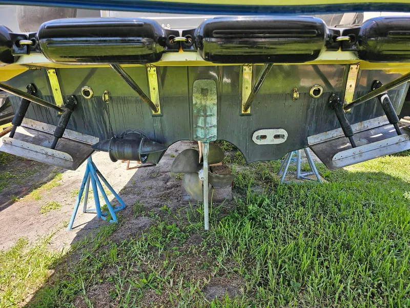 Slide: The Image of 2014 Ranger Tugs 31-CB boat hull on stands, showing propeller and rudder. - 14