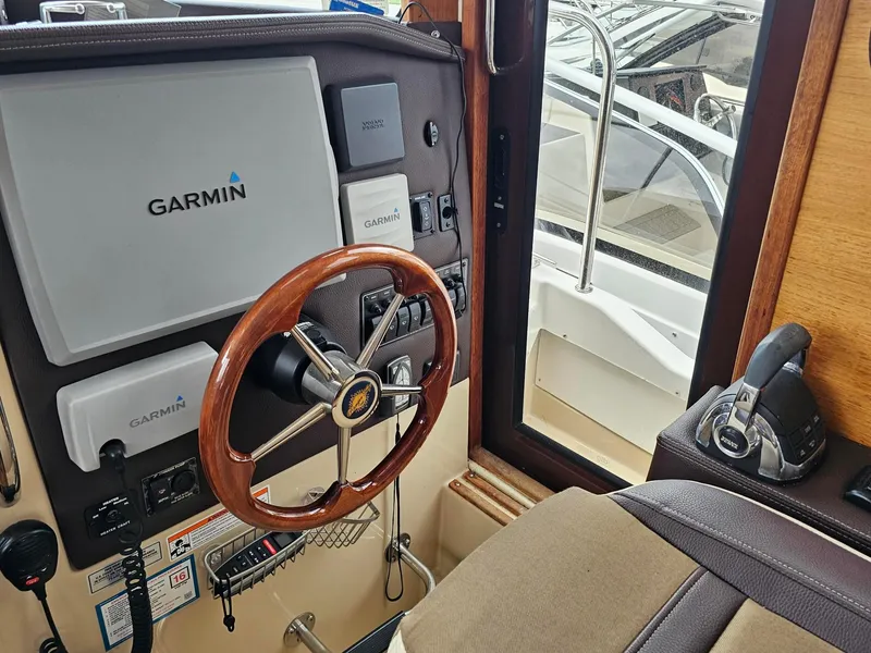 Slide: The Image of 2014 Ranger Tugs 31-CB helm with Garmin navigation and wooden steering wheel. - 20