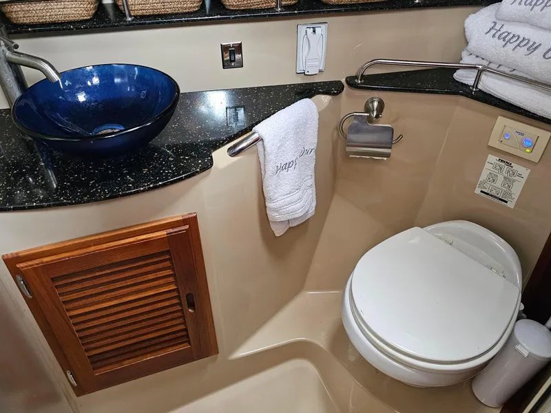 Slide: The Image of 2014 Ranger Tugs 31-CB bathroom with blue vessel sink and modern amenities. - 22