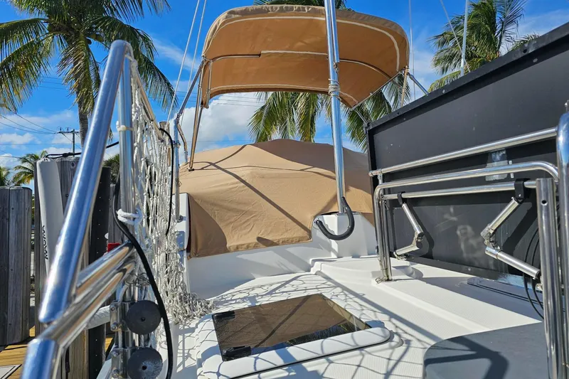 Slide: The Image of 2014 Ranger Tugs R 31 boat deck with canopy, surrounded by palm trees. - 28