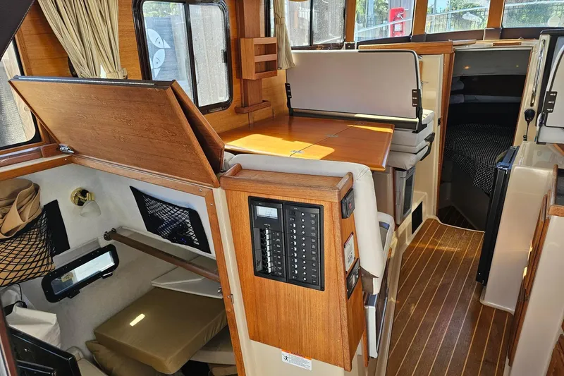 Slide: The Image of 2014 Ranger Tugs R 31 interior with wood accents and seating area. - 31