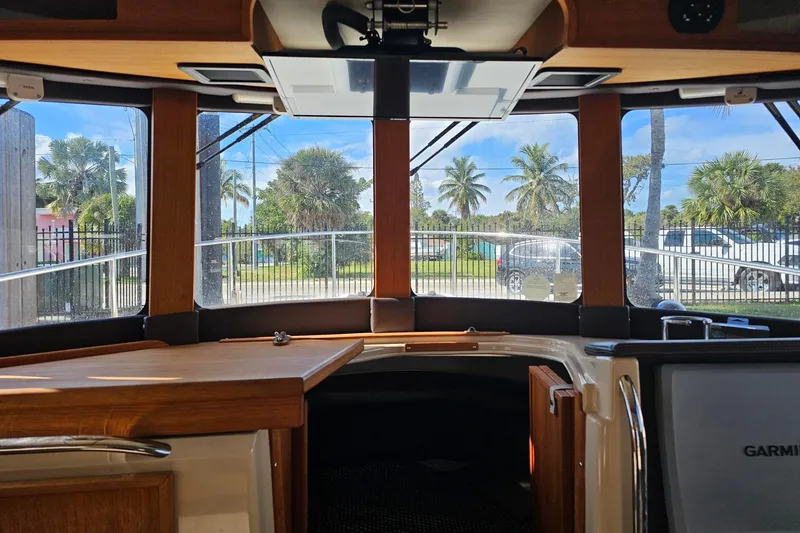 Slide: The Image of Interior view of 2014 Ranger Tugs R 31 boat with large windows and wooden accents. - 35