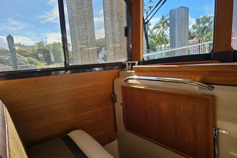 Slide: The Image of Interior view of 2014 Ranger Tugs R 31 boat with wooden paneling and window. - 36