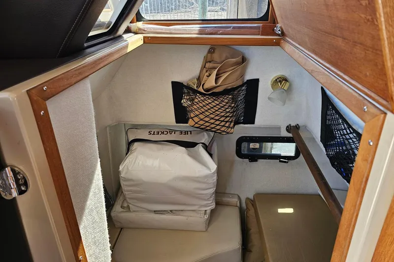Slide: The Image of 2014 Ranger Tugs R 31 cabin interior with life jackets and storage nets. - 38