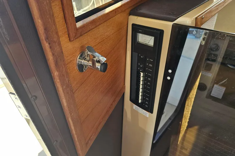 Slide: The Image of 2014 Ranger Tugs R 31 interior with control panel and wooden finish. - 39