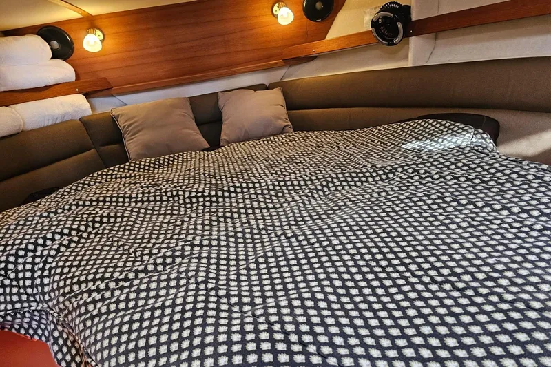 Slide: The Image of Cozy cabin interior of 2014 Ranger Tugs R 31 with patterned bedding and ambient lighting. - 41