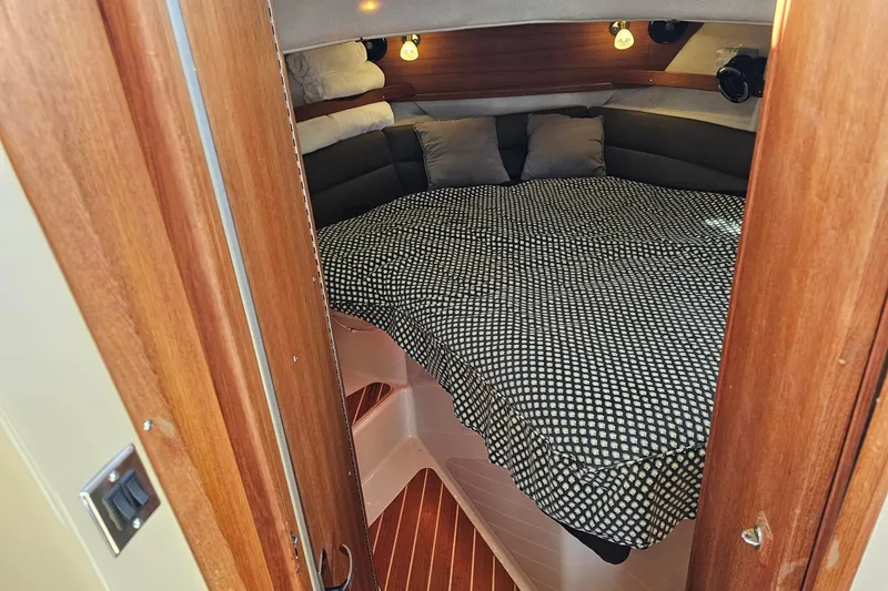 Slide: The Image of Cozy cabin interior of 2014 Ranger Tugs R 31 with patterned bedding and wooden accents. - 42