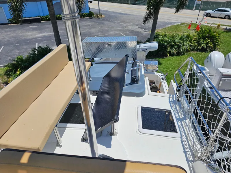 Slide: The Image of 2014 Ranger Tugs 31-CB boat deck with seating, netting, and equipment under sunny skies. - 8
