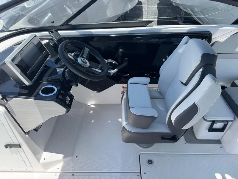 Slide: The Image of 2025 Yamaha Boats AR250 cockpit with steering wheel, touchscreen display, and comfortable seating. - 20