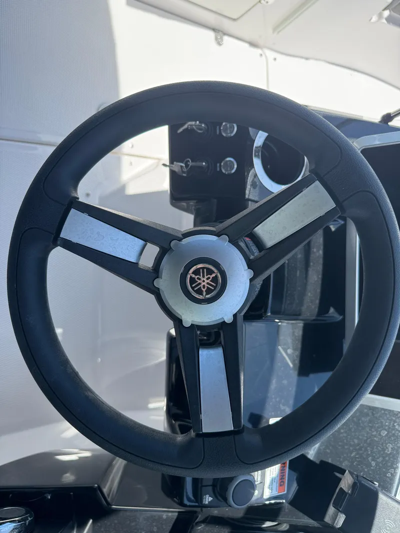 Slide: The Image of Steering wheel of 2025 Yamaha Boats AR250, showcasing sleek design and controls. - 26