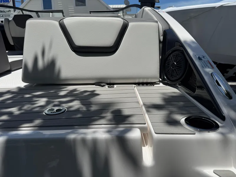 Slide: The Image of 2025 Yamaha Boats AR250 interior with cushioned seating and speaker system. - 31