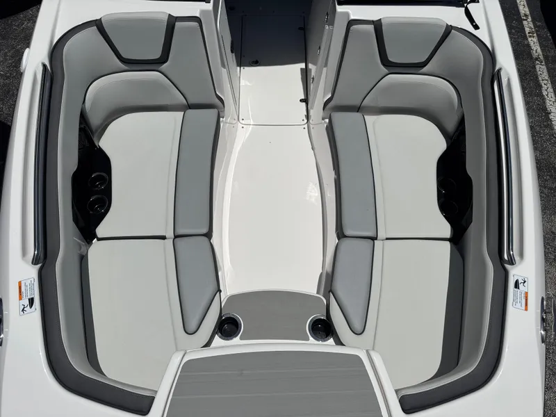 Slide: The Image of 2025 Yamaha Boats AR250 interior seating, featuring sleek gray and white upholstery. - 8