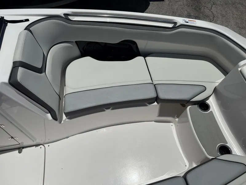 Slide: The Image of 2025 Yamaha Boats AR250 interior seating with gray and white upholstery. - 9