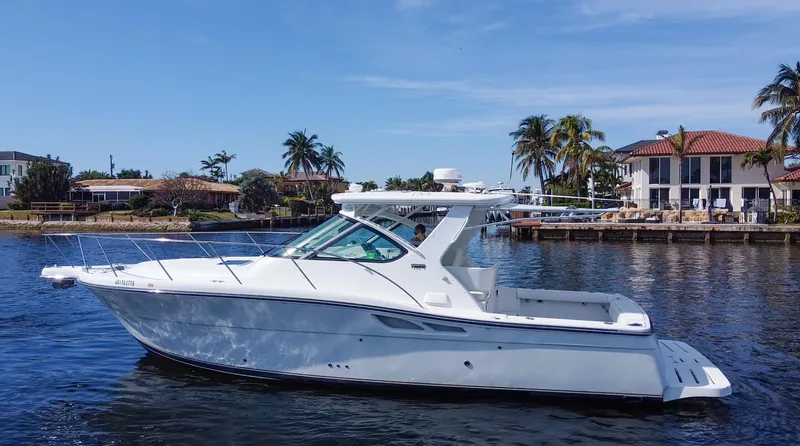The Image of 2006 Tiara Yachts 3200 Open cruising on a sunny day near waterfront homes. - 0