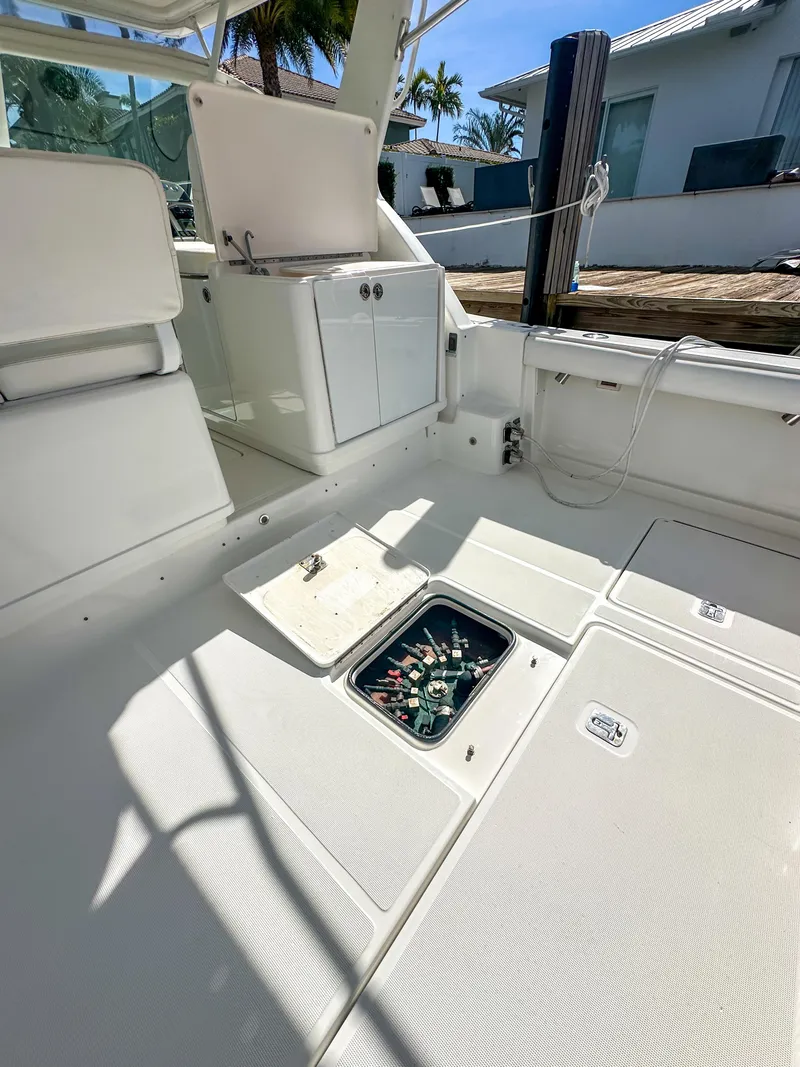 Slide: The Image of 2006 Tiara Yachts 3200 Open interior with storage compartment, docked under sunny skies. - 15