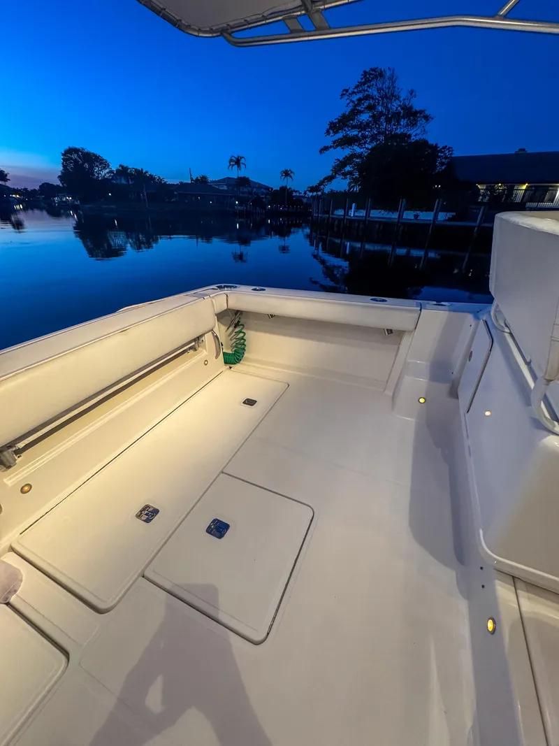 Slide: The Image of 2006 Tiara Yachts 3200 Open boat deck at dusk, reflecting serene waterfront views. - 18
