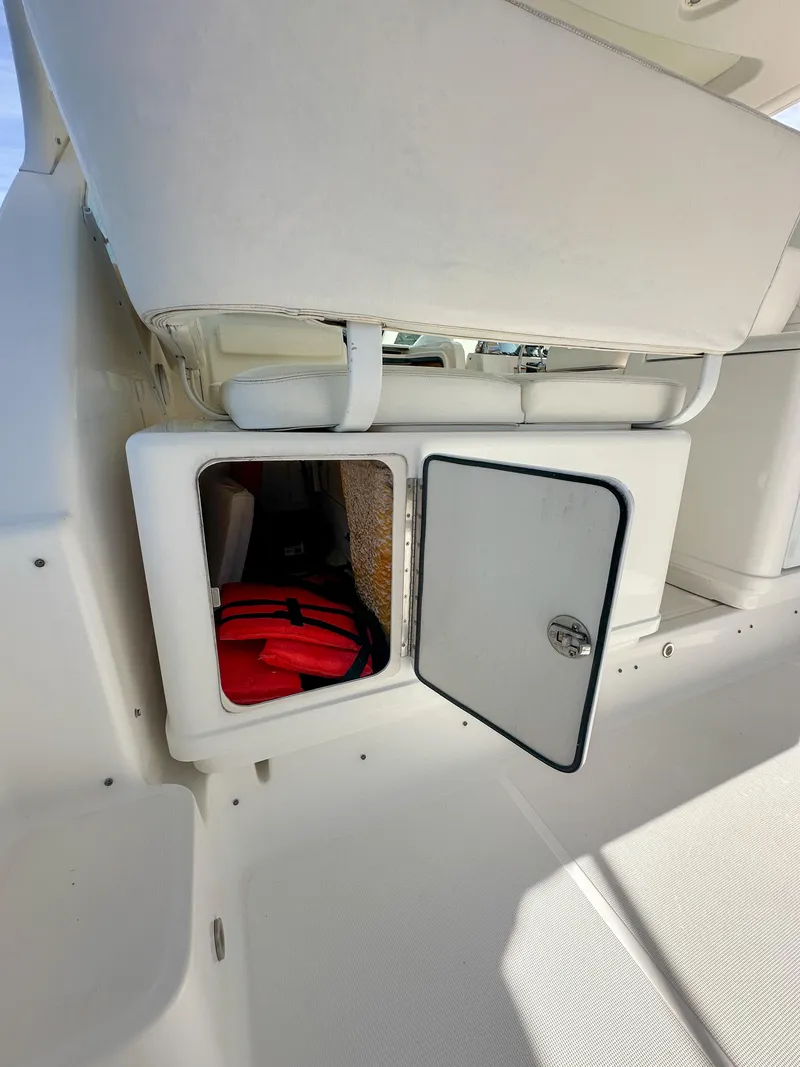 Slide: The Image of Storage compartment on 2006 Tiara Yachts 3200 Open, featuring a red life jacket. - 24