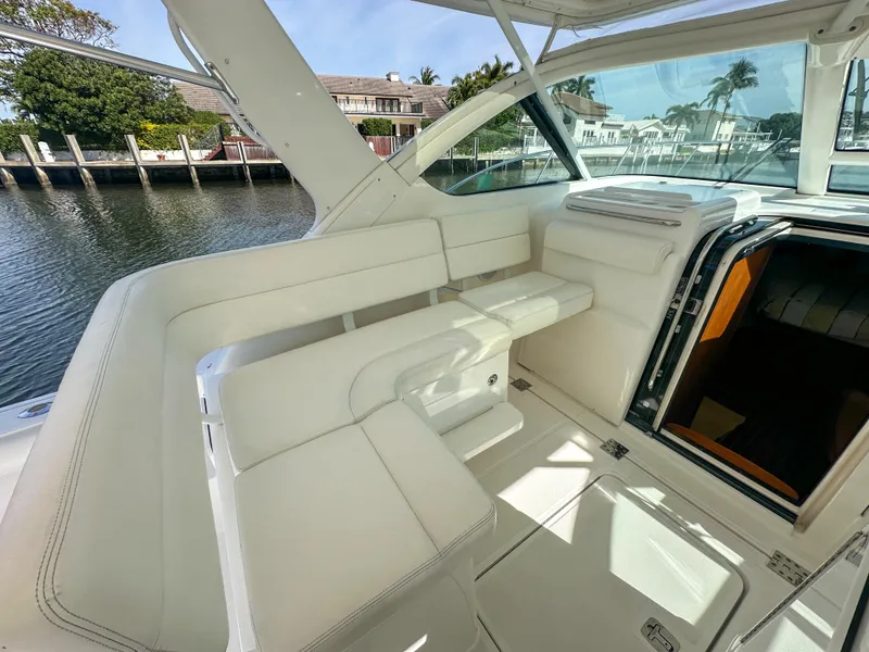 Slide: The Image of 2006 Tiara Yachts 3200 Open interior with white seating and waterfront view. - 26