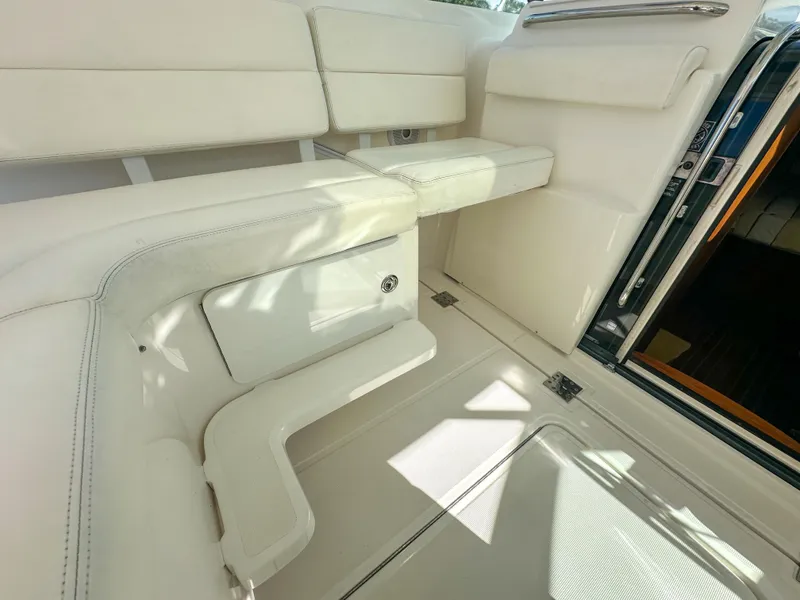Slide: The Image of 2006 Tiara Yachts 3200 Open interior with white seating and storage compartment. - 27